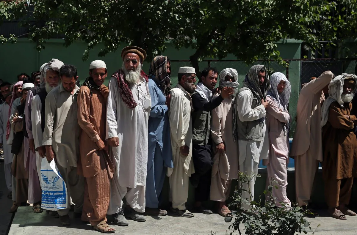 Afghan men wait in line to receive food donation during the holy month of Ramadan in Kabul, Afghanistan, Thursday, June 25, 2015. Muslims throughout the world are marking the month of Ramadan, the holiest month in the Islamic calendar during which devotees fast from dawn till dusk. (AP Photo/Massoud Hossaini)