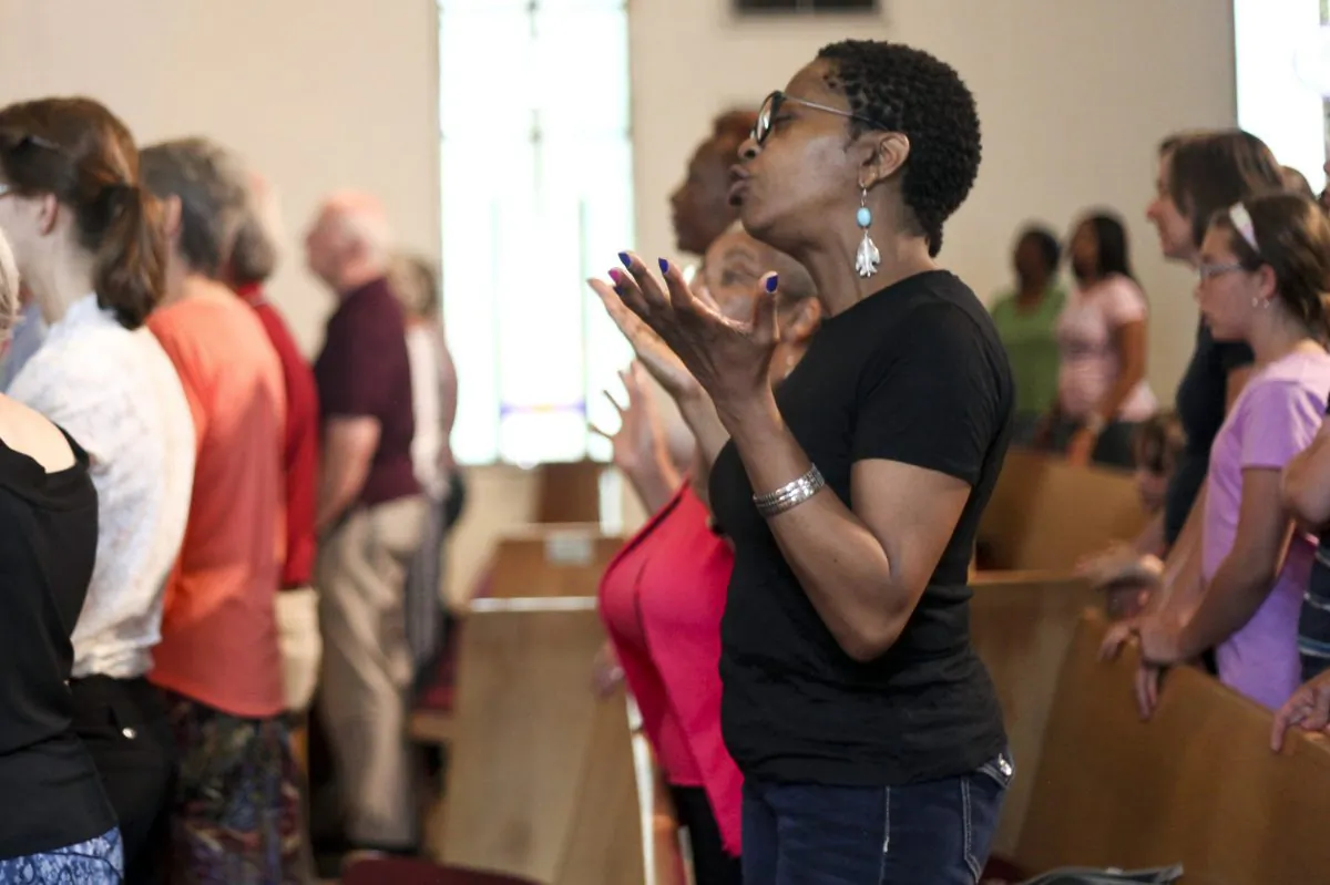 People attend a service in remembrance of the nine people killed in Charleston, S.C., Wednesday, June 24, 2015, at the African Methodist Episcopal Church in Kalamazoo, Mich. (Daytona Niles/Kalamazoo Gazette-MLive Media Group via AP) 