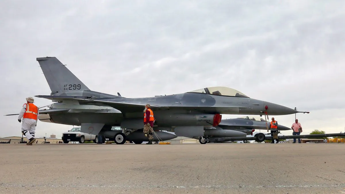 In this May 15, 2015, file photo, a boneyard crew tows an F-16 Fighting Falcon aircraft prior to the preservation process after its arrival at the 309th Aerospace Maintenance and Regeneration Group at Davis-Monthan Air Force Base in Tucson, Ariz. (AP Photo/Matt York)
