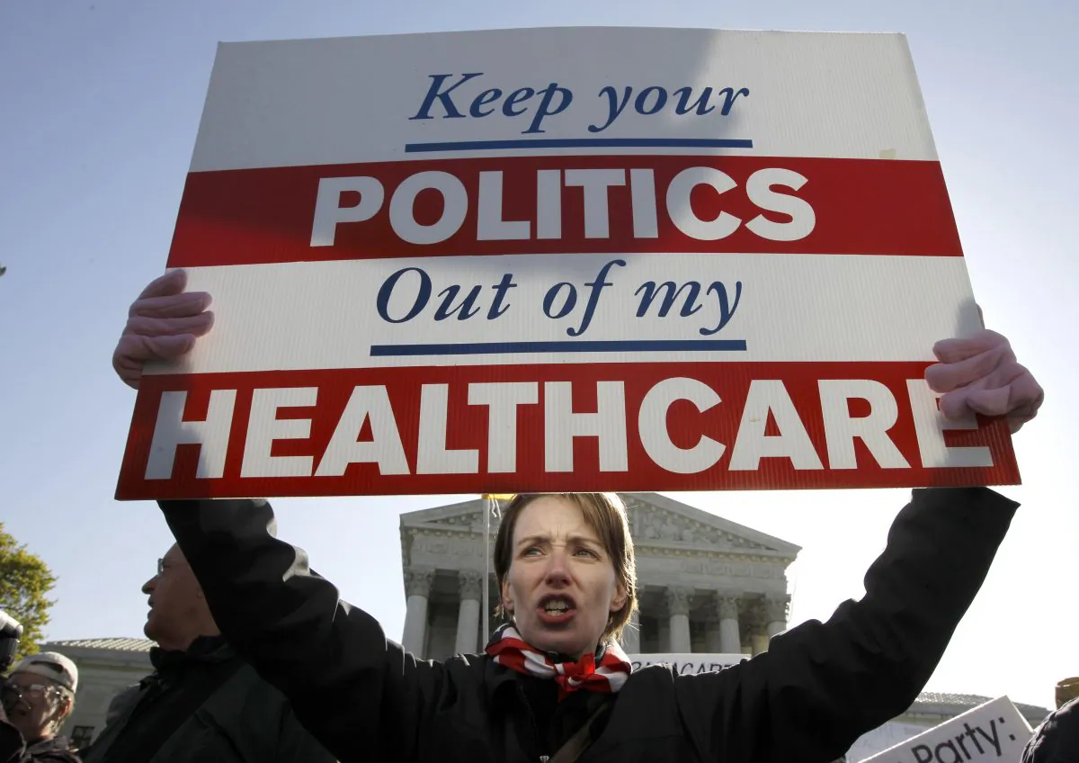 Amy Brighton from Medina, Ohio, who opposes health care reform, holds a sign in front of the Supreme Court in Washington, D.C., on March 27, 2012, during a rally as the court continues arguments on the health care law signed by President Barack Obama. (AP Photo/Charles Dharapak)