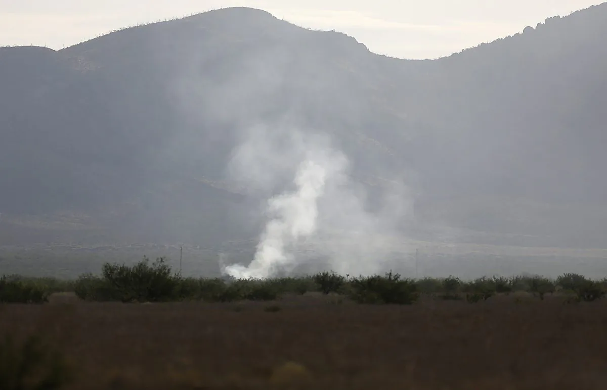 Smoke rises Thursday, June 25, 2015, from the site where an F-16 Fighting Falcon crashed Wednesday evening near Douglas, Ariz. (Mamta Popat/Arizona Daily Star via AP)