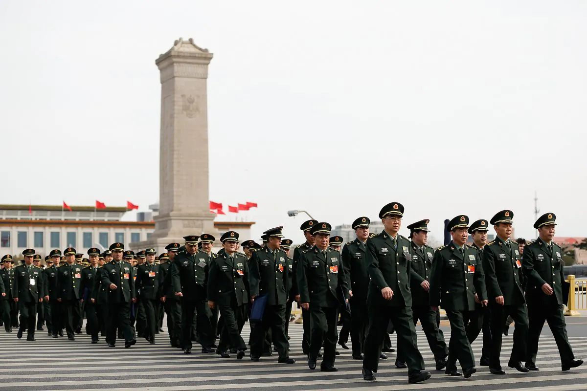 Delegates from Chinese People's Liberation Army attend the second plenary session of China's parliament on March 8 in Beijing, China. The Chinese regime is shifting its military focus to cyber and space. (Lintao Zhang/Getty Images)