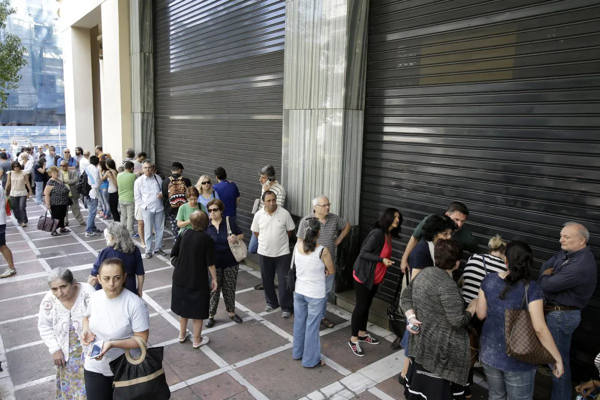 People stand in a queue outside a bank which operates on Saturday but eventually didn't open, in central Athens, on June 27, 2015. (AP Photo/Thanassis Stavrakis)