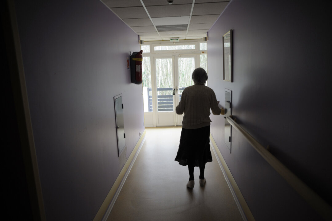 A woman, suffering from Alzheimer's disease, walks in a corridor in a retirement house in Angervilliers, eastern France, on March 18, 2011. (Sebastien Bozon/AFP/Getty Images)