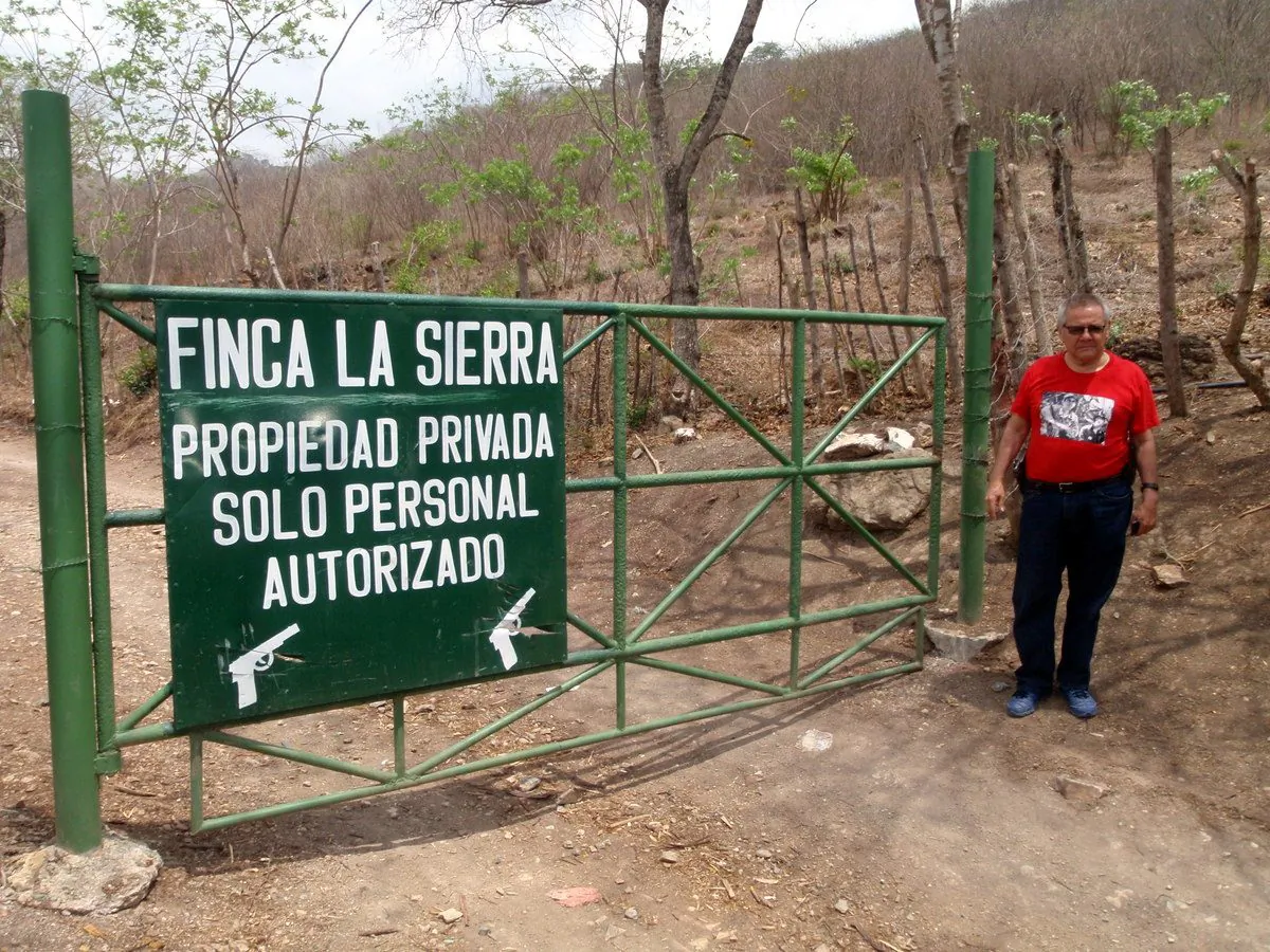 Fundacion Turcios Lima President Cesar Montes at gate established to keep people from access to public domain and the protected biosphere forest of Sierra de las Minas. (John Christopher Fine copyright 2015)