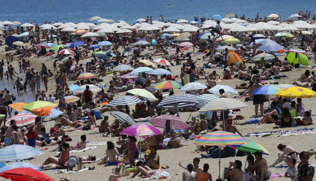 People sunbathe on a beach in Barcelona, Spain, Sunday, June 28, 2015. (AP Photo/Manu Fernandez)