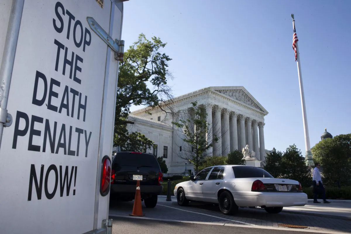 A vehicle parked near the Supreme Court in Washington, has signage that says "Stop The Death Penalty Now," Monday June 29, 2015. (AP Photo/Jacquelyn Martin)