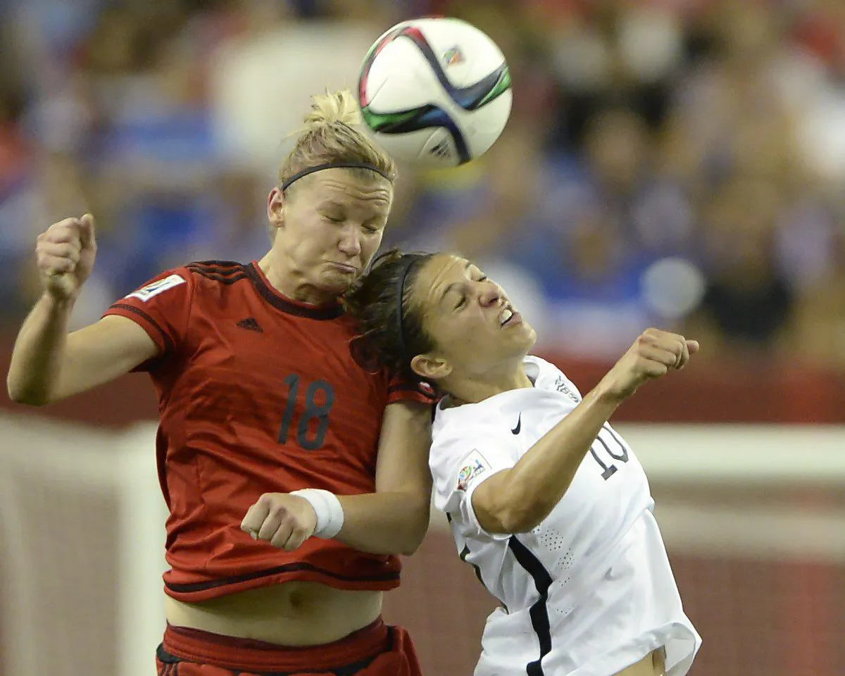 Germany's Alexandra Popp (18) and USA's Carli Lloyd (10) battle for a header in Women's World Cup semifinal action in Montreal on June 30, 2015. (The Canadian Press/Ryan Remiorz)