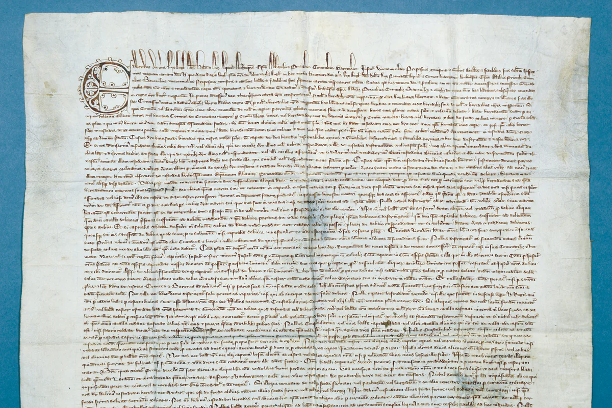 The 1300 Magna Carta, written on parchment, begins with a decorated initial “E” (for Edward I or Edward Longshanks, son of Henry III). (Chapter of Durham Cathedral)