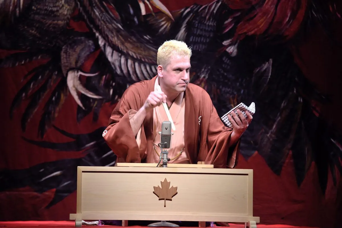 Katsura Sunshine on stage using one of only two props to illustrate the story he is telling. (Courtesy of Katsura Sunshine)