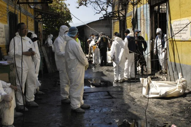 Forensic personnel remove the charred remains of inmates at the National Prison compound in Comayagua, Honduras, on February 15, 2012. (Orlando Sierra/AFP/Getty Images)