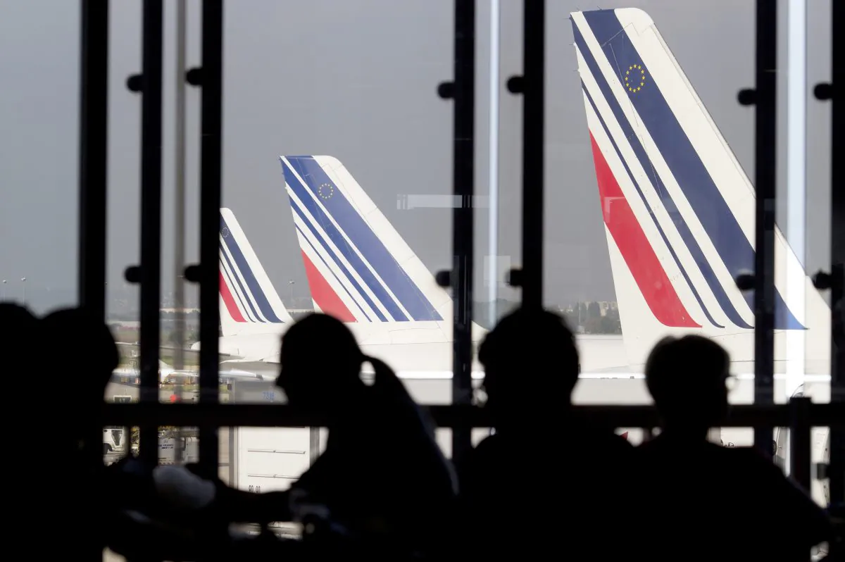 Passengers wait in a lounge as Air France planes are seen behind at Paris-Orly airport on Sept. 15, 2014. (Kenzo Tribouillard/AFP/Getty Images)