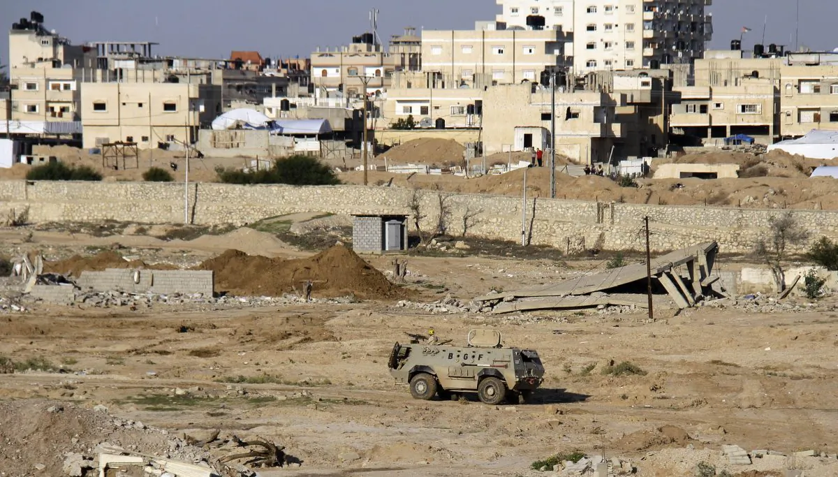 In this Nov. 6, 2014 file photo, an Egyptian army armored vehicle stands on the on the Egyptian side of border town of Rafah, north Sinai, Egypt. Islamic militants on Wednesday, July 1, 2015 unleashed a wave of simultaneous attacks, including suicide car bombings, on Egyptian army checkpoints in the restive northern Sinai Peninsula, killing at least tens of soldiers, security and military officials said. (AP Photo/Ahmed Abd El Latif, El Shorouk Newspaper, File)
