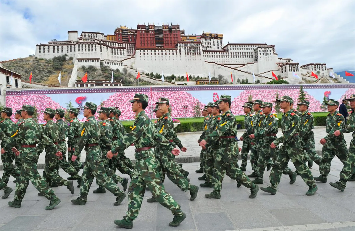 Chinese paramilitary policemen patrol in front of the Potala Palace during the ceremony for the 2008 Beijing Olympic Games torch relay in Lhasa on June 21, 2008. (TEH ENG KOON/AFP/Getty Images)
