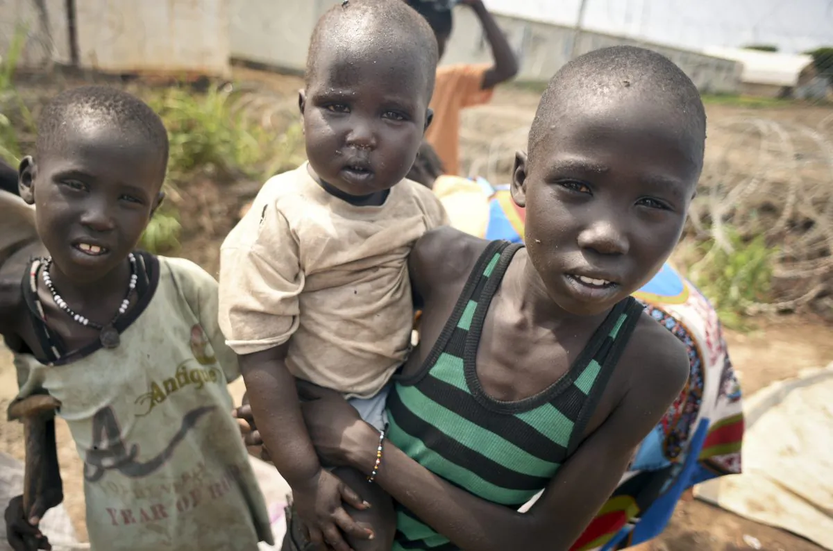 In this photo taken Saturday, June 27, 2015, newly-arrived displaced children, whose village had been burned, stay at the UN base in Bentiu, South Sudan. South Sudans army has burned people alive, raped and shot girls, and forced tens of thousands from their homes, according to interviews with survivors by The Associated Press and corroborated by human rights groups. (AP Photo/Jason Patinkin)