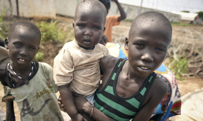 In this photo taken Saturday, June 27, 2015, newly-arrived displaced children, whose village had been burned, stay at the UN base in Bentiu, South Sudan. South Sudans army has burned people alive, raped and shot girls, and forced tens of thousands from their homes, according to interviews with survivors by The Associated Press and corroborated by human rights groups. (AP Photo/Jason Patinkin)