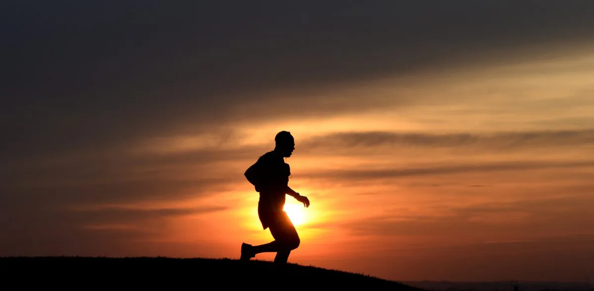 A jogger runs during the sunset after a warm spring day on March 16, 2015, in the Olympic park in Munich, southern Germany. Meteorologists forecast temperatures around 15 degrees and further sun in the region. AFP PHOTO/CHRISTOF STACHE        (Photo credit should read CHRISTOF STACHE/AFP/Getty Images)