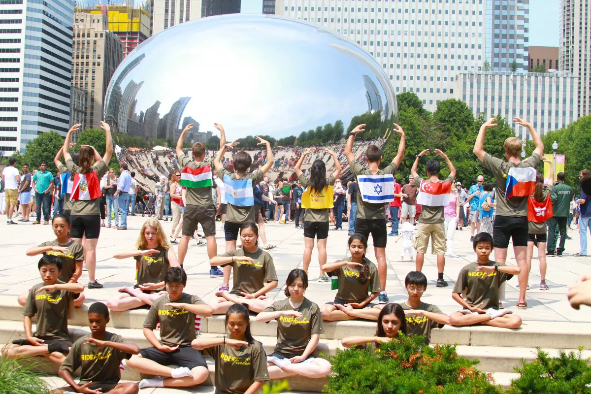 Ride2Freedom cyclists demonstrate the Falun Gong exercises in Chicago's Millennium Park, July 3, 20015. (Chris Jasurelk/Epoch Times)