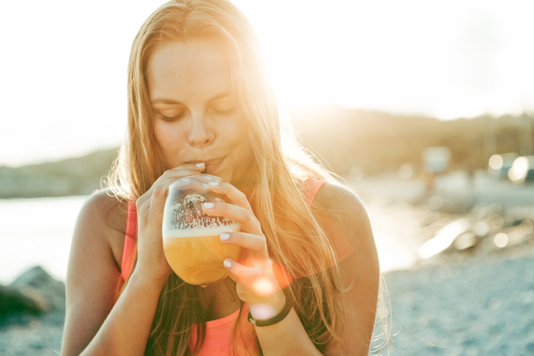 It's still a good idea to sip water in between the beer, wine, or fancy cocktails with a tiny umbrella, but it takes more to catch up than you may realize. (A75/iStock) 