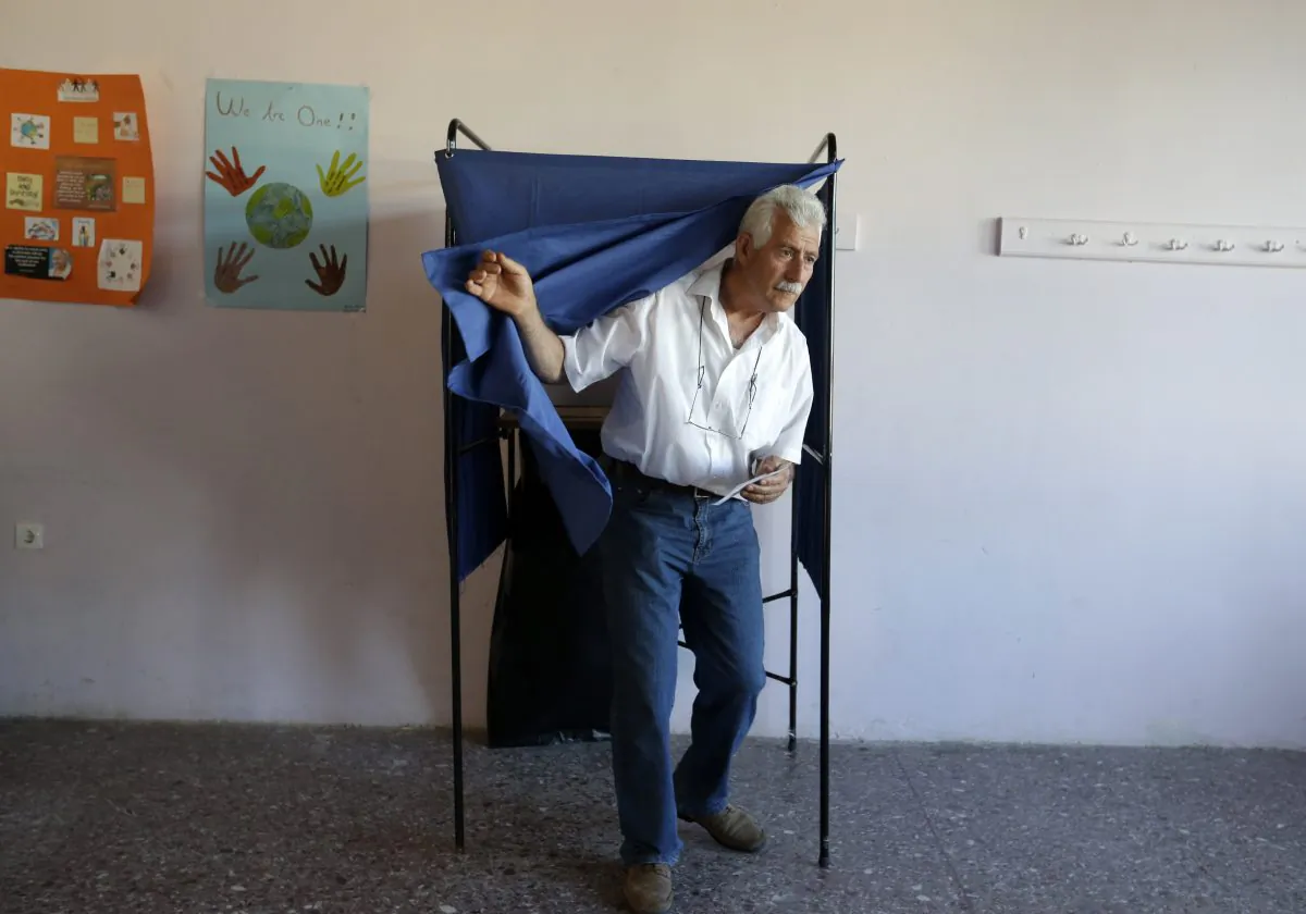 A man casts his vote at polling station in Athens, Sunday, July 5, 2015. (AP Photo/Thanassis Stavrakis)