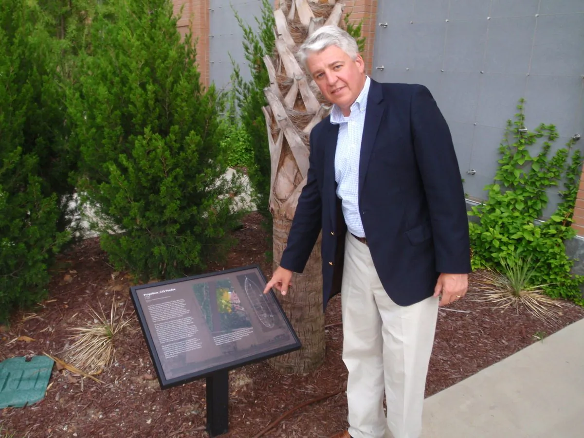 Ben Zeigler with plaque describing the history of the CSS Pedee in Florence Museum's garden. (John Christopher Fine copyright 2015)