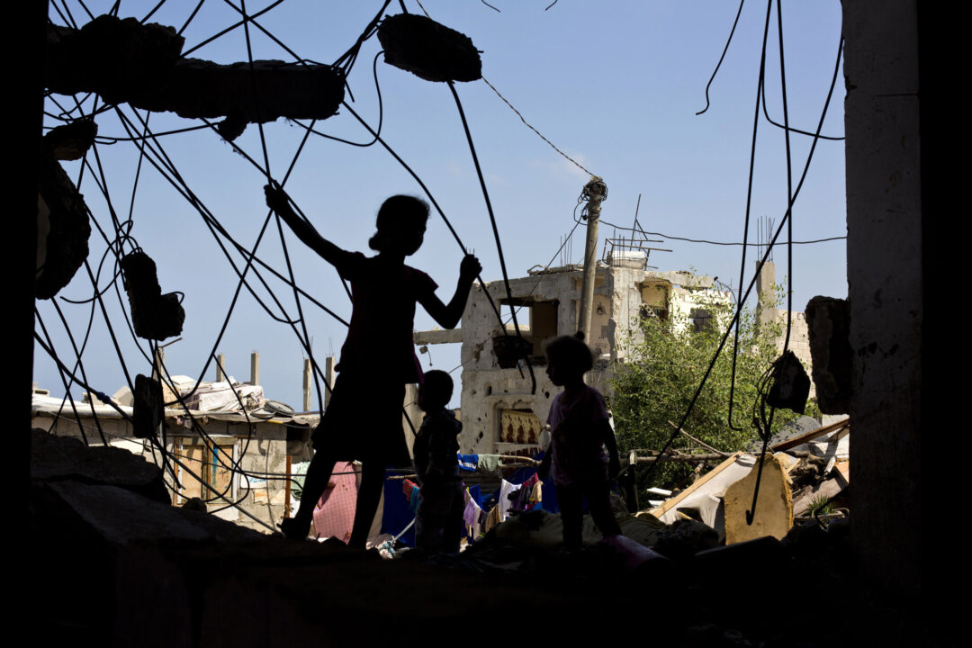 Palestinian children play on July 2, 2015, in the rubble of a building that was destroyed during the 50-day war between Israel and Hamas' militants in the summer of 2014, in the al-Shejaeiya neighbourhood, east of Gaza City. (Mohammed Abed/AFP/Getty Images)