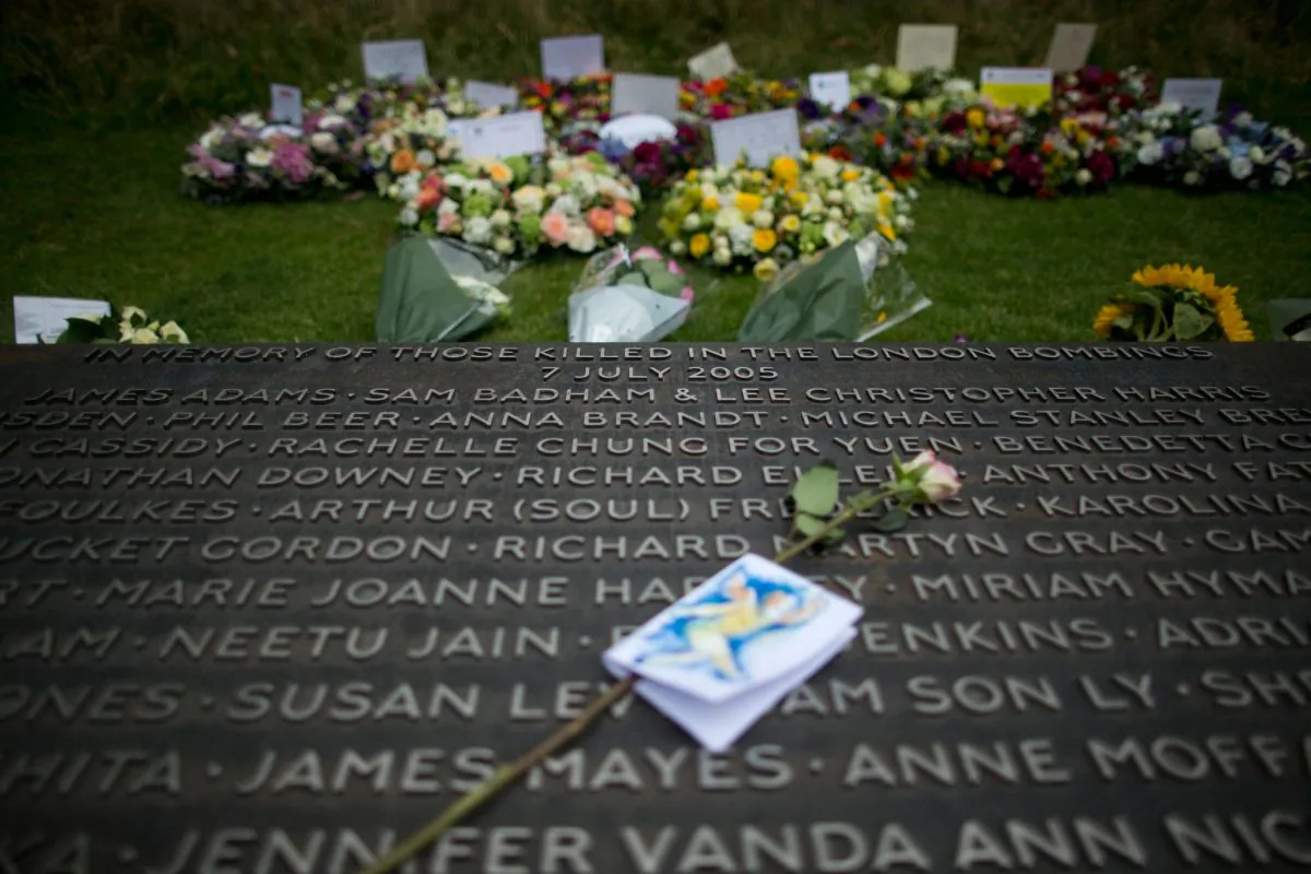 Floral wreaths lie beside a plaque bearing the names of victims at the 7/7 memorial, on the 10th anniversary of the attacks, in Hyde Park, London, on July 7, 2015. (AP Photo/Matt Dunham)
