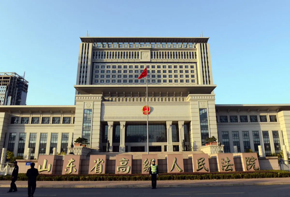 In this file photo, a Chinese policeman stands guard outside the Shandong high court building in Jinan, east China Shandong province on October 24, 2013. (Goh ChaiI Hin/AFP/Getty Images)