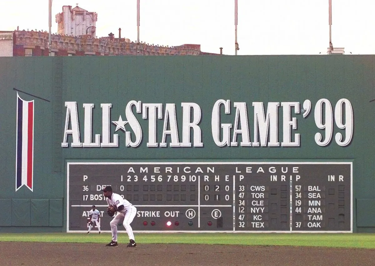 Fenway Park's famed left field wall, "The Green Monster," decorated for the 1999 All-Star game upcoming in July, looms behind Red Sox second baseman Jose Offerman during the second inning against the Detroit Tigers in Boston Tuesday night, June 1, 1999. (AP Photo/Elise Amendola) 