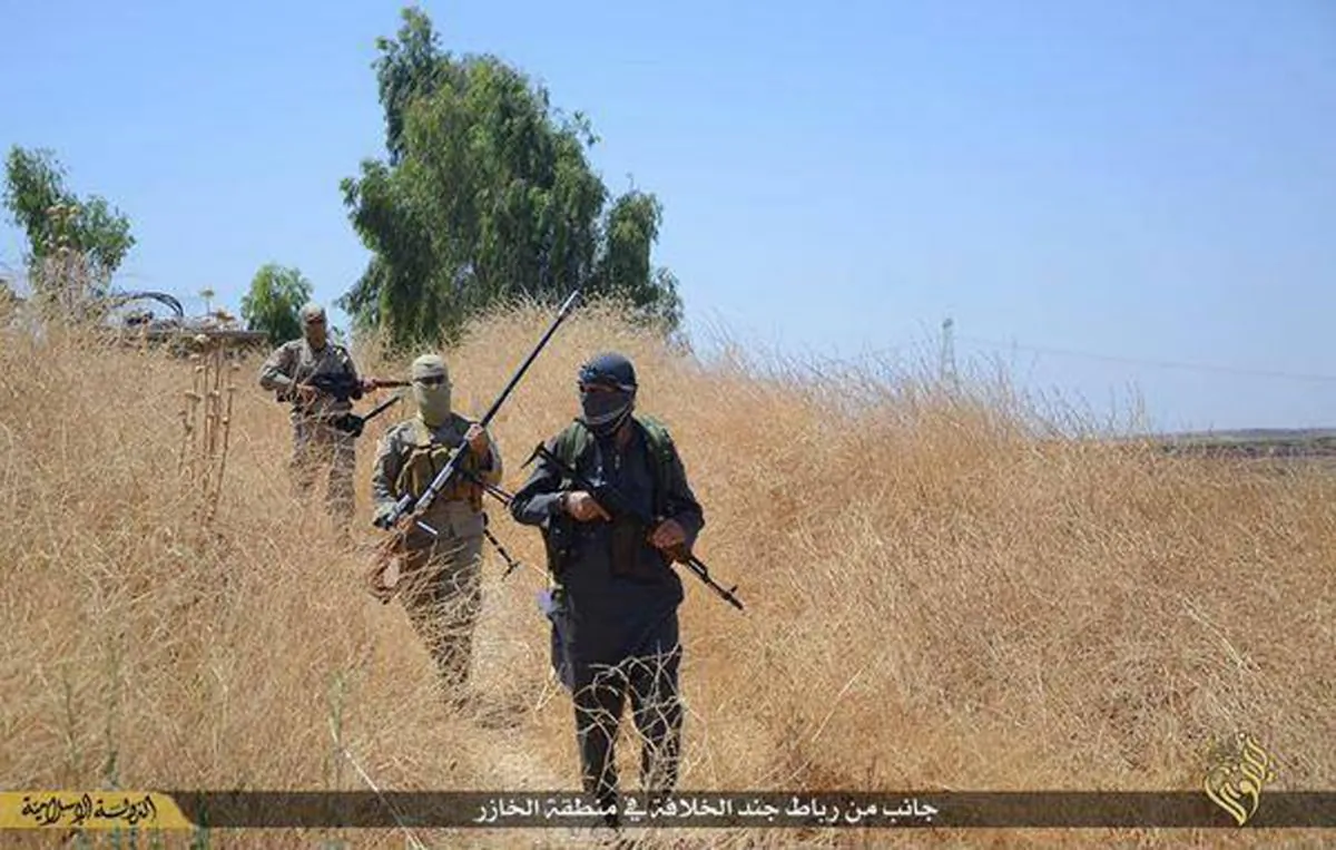 In this photo released on June 23, 2015, by a website of Islamic State militants, Islamic State militants patrol Khazer, Iraq, near Mosul. (Militant website via AP)