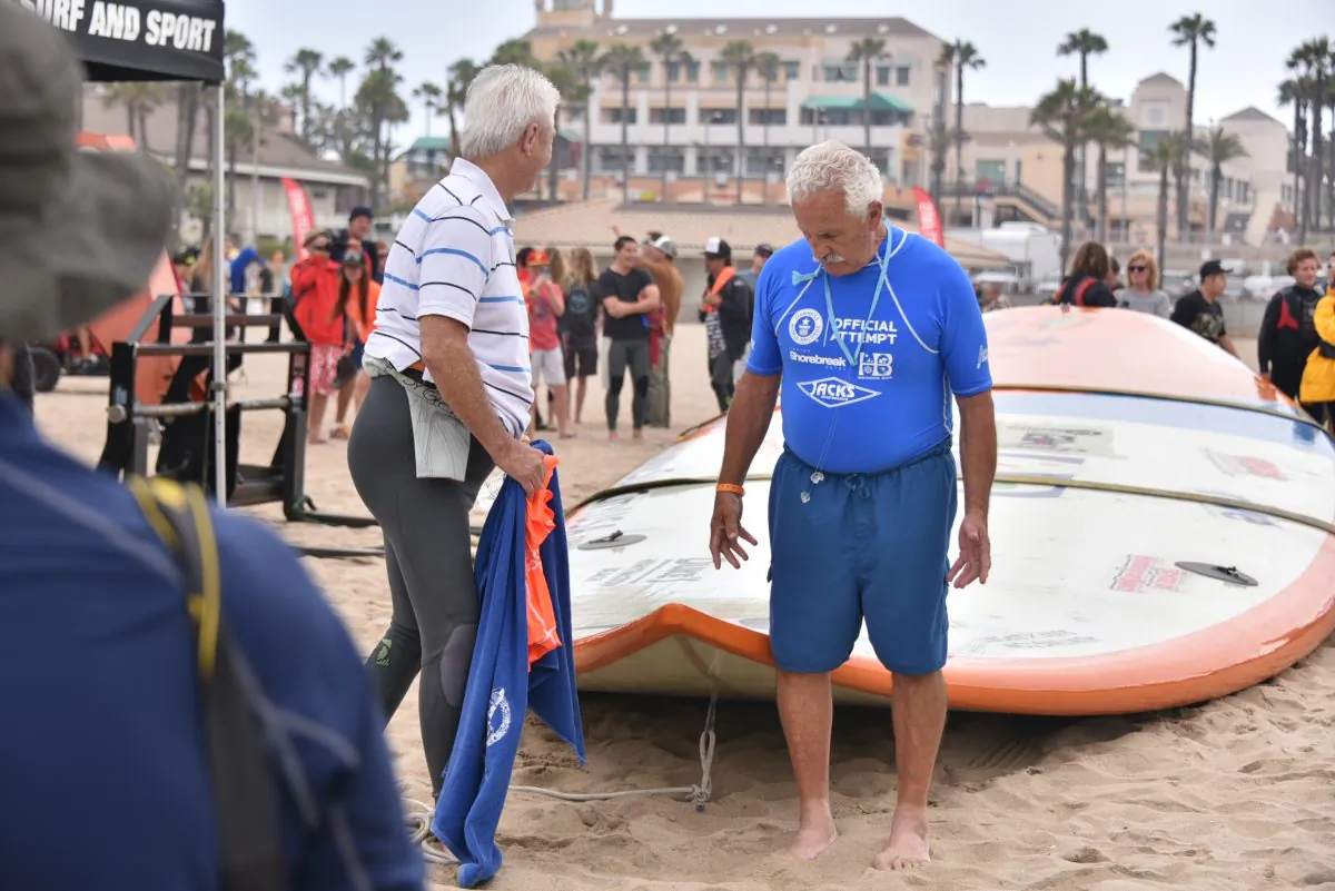 The world’s biggest surfboard, measuring 42 feet long and 11 feet wide, sits on the sand at Huntington Beach, Calif., June 20. Guinness Records declared it the new record-holder, but will make more precise measurements in the future. (Robin Kemker/Epoch Times)