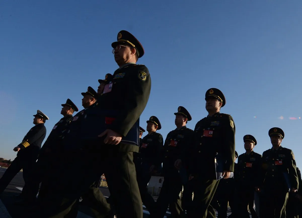 Military delegates arrive for the National People’s Congress (NPC) at the Great Hall of the People in Beijing on March 5, 2014. China’s new national security law passed by the National People’s Congress (NPC) Standing Committee on July 1, 2015 is criticized and rejected. (Mark Ralston/AFP/Getty Images) 