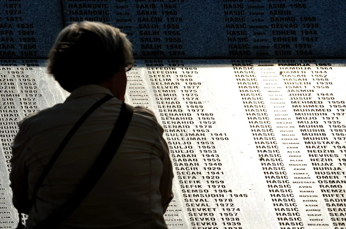 A visitor stands in front of the memorial wall at the Potocari Memorial cemetery near the Eastern-Bosnian town of Srebrenica, on July 4, 2013. (Elvis Barukcic/AFP/Getty Images)