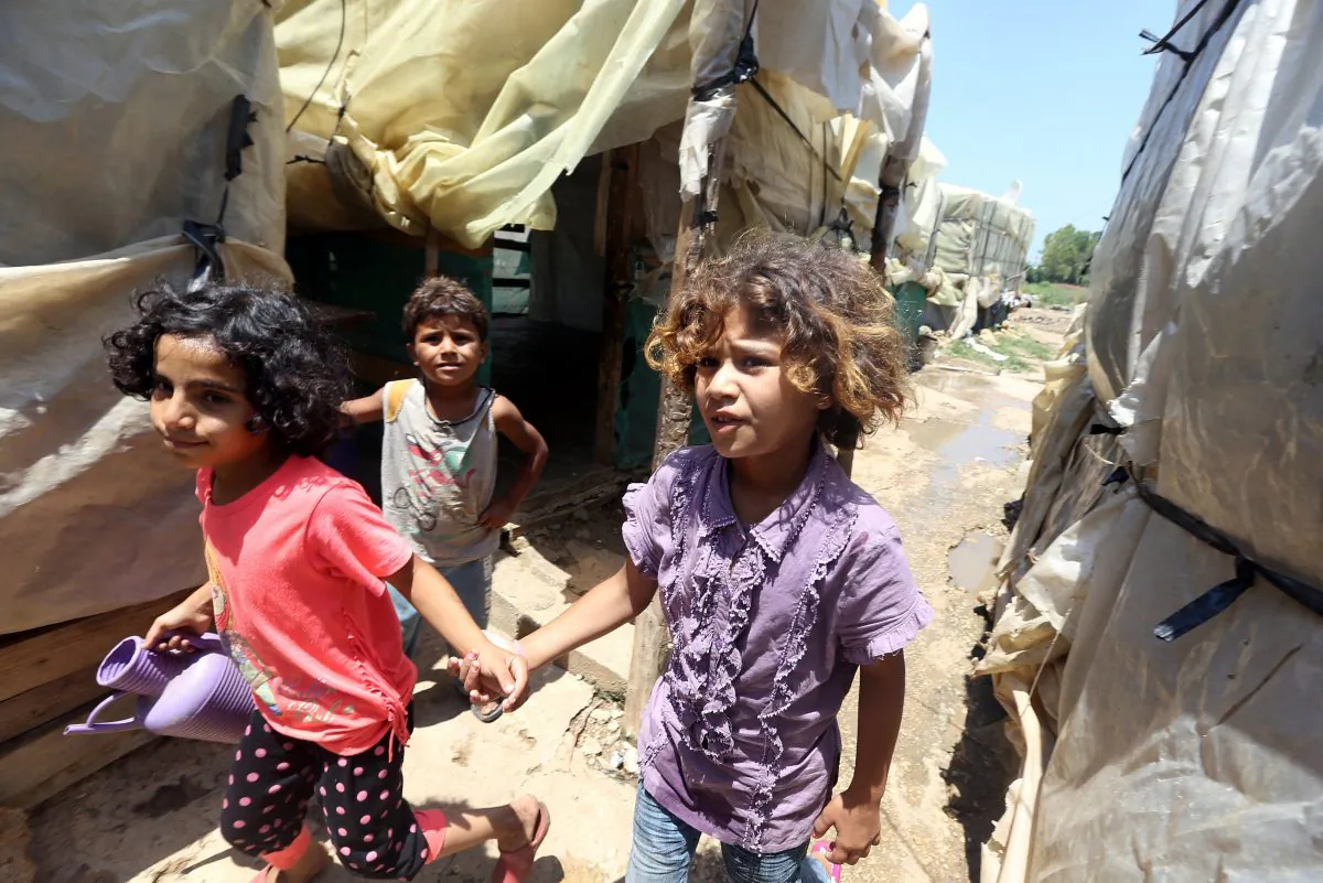 Syrian refugee children walk at an informal refugee camp in the area of Zahrani, south of the Lebanese capital Beirut, on July 9, 2015. (Joseph Eid/AFP/Getty Images)