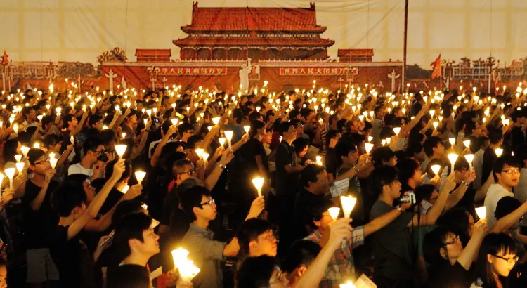 Participants at the 180,000-strong Tiananmen Square Massacre Candlelight Vigil in Hong Kong hold up candles and posters, commemorating the victims, on June 4, 2012. (Sung Pi Lung/The Epoch Times)