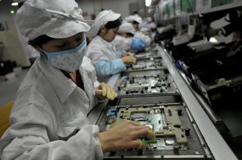 Chinese workers assemble electronic components at the Taiwanese technology giant Foxconn's factory in Shenzhen, in the southern Guangzhou Province, on May 26. (AFP/Getty Images)