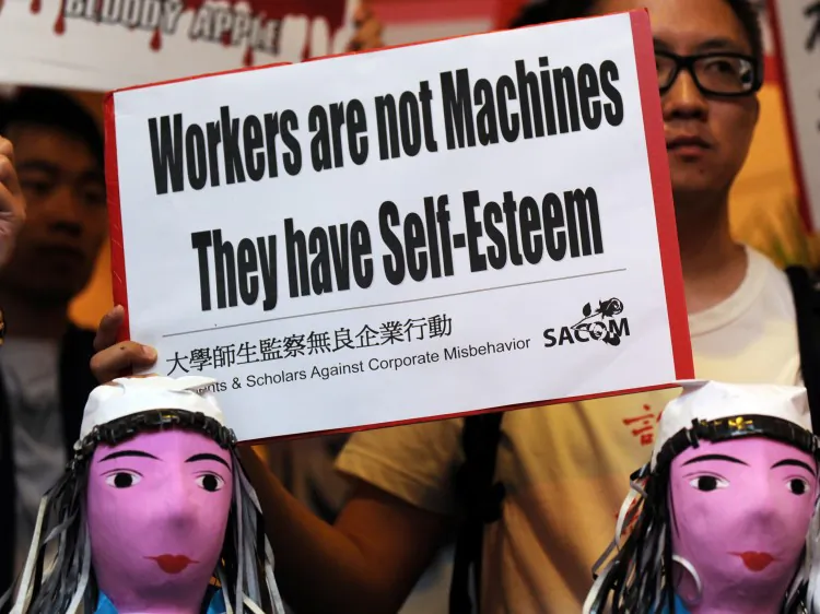Students protest with model effigies of workers who have committed suicide at Foxconn in China during the company’s annual general meeting in Hong Kong on June 8, 2010. The difficult life at the electronics giant has caused despair in its workers. (Mike Clarke/AFP/Getty Images)