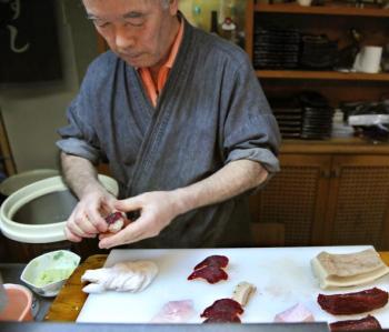 Katsuji Furuuchi makes up a whale sushi from a sliced minke meat and a rice ball in Japanese whaling town Ayukawahama, Miyagi prefecture. (Kazuhiro Nogl/AFP/Getty Images)