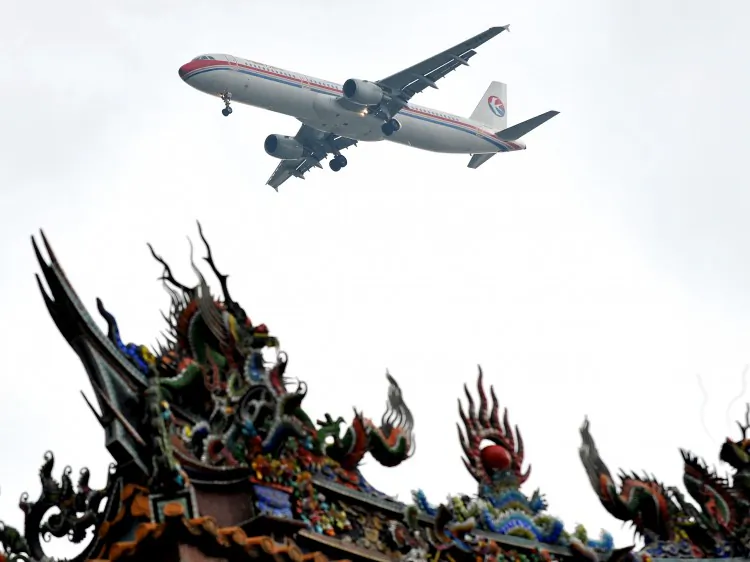 A China Eastern Airlines jet flies over a temple before landing in Taipei on June 29, 2010. Zeng Qinghong laundered money through the airlines to Taiwan in 2002. (Patrick Lin/AFP/Getty Images)