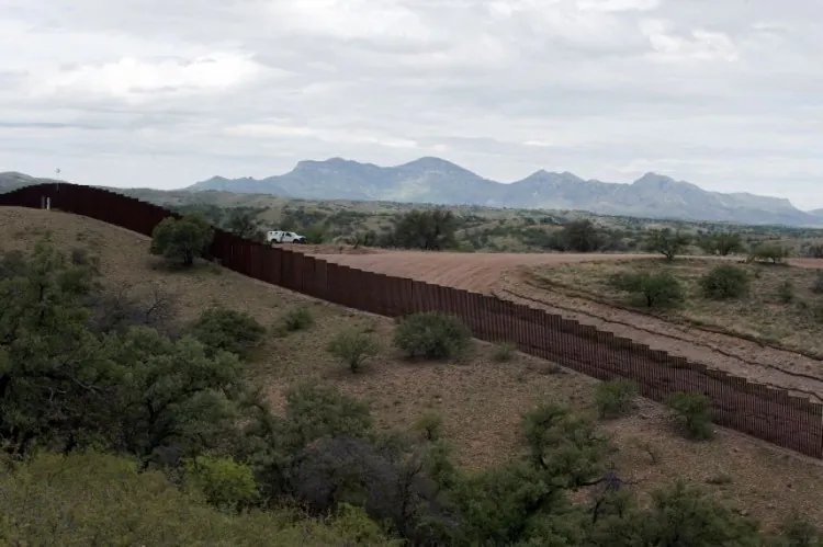 A US Border Patrol vehicle drives along the fence separating the US from Mexico, near the town of Nogales, Sonora, Mexico, on July 31, 2010. Since the creation of CBP in March 2003, the U.S. Border Patrol more than doubled in size to a force today of 21,370 agents. (Alfredo Estrella/AFP/Getty Images)