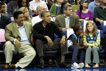 US President Barack Obama (C) attends the Washington Mystics basketball game with his daughter Sasha (2nd R) and her friend (R) at the Verizon Center in Washington, DC, August 1, 2010. (Jim Watson/AFP/Getty Images)