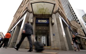 People walk past a branch of the Royal Bank of Scotland (RBS), in the City of London on August 4, 2010.  (Ben Stansall/Getty Images)