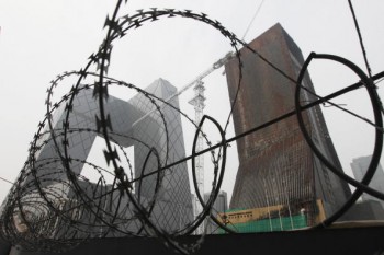 The China Central Television (CCTV) complex is pictured behind a barbed-wire fence in Beijing on Aug. 13, 2010. (Lee/AFP/Getty Images)