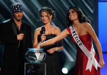 Miss Universe 2010 Jimena Navarrete (R) chooses an interview question before pageant hosts Bret Michaels (L) and Natalie Morales (C)  at the Mandalay Bay Hotel in Las Vegas on Aug. 23. (Mark Ralston/AFP/Getty Images)