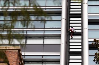 'French Spiderman' Alain Robert climbs 57-storey Lumiere Building on Aug. 30 in Sydney. Robert, who has scaled more than 85 structures around the world, successfully climbed the Lumiere building in 25 minutes. (Craig Golding/Getty Images)