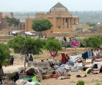 Pakistani flood survivors take shelter in southern Sindh province's Makli on August 31. Flood waters that have devastated Pakistan, covering a fifth of the country and leaving at least 1,600 people dead, are now draining into the Arabian Sea.   (Rizwan Tabass/Getty Images )