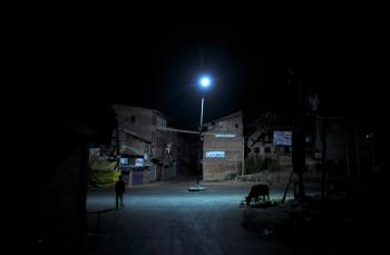 A man walks past a cow grazing in a deserted street of Srinagar on September 12, 2010. Authorities imposed an indefinite curfew in Srinagar and other Jammu and Kashmir towns today, a day after the city saw widespread violent protests. (Sajjad Hussain/Getty Images )