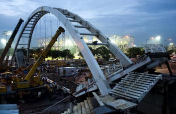 Indian workers dismantle the collapsed footbridge at the Jawaharlal Stadium, the main venue for the forthcoming Commonwealth Games, in New Delhi on Sept. 21. (Manpreet Romana/AFP/Getty Images) Indian workers dismantle the collapsed footbridge at the Jawaharlal Stadium, the main venue for the forthcoming Commonwealth Games, in New Delhi on Sept. 21. (Manpreet Romana/AFP/Getty Images)