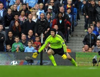 Man City's Argentinian striker Carlos Tevez (R) shoots past Chelsea's Czech goalkeeper Petr Cech to score the only goal of the English Premier League football match at the City Of Manchester Stadium in Manchester, Sept. 25. (Andrew Yates/AFP/Getty Images)