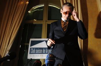 Wikileaks founder Julian Assange removes his glasses prior to a press conference at the Geneva Press Club on November 4. Ecuador, has invited Assange, to come to the country to do research and give classes. (Fabrice Coffrini/Getty Images)